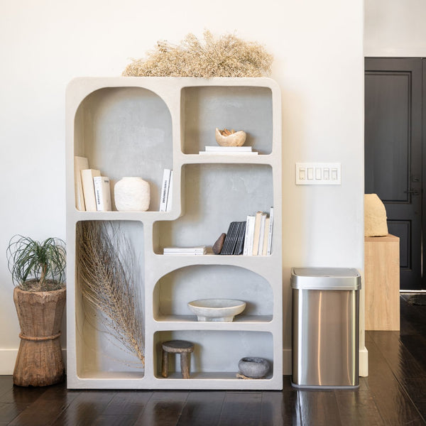 13 gallon uv light trash can beside a bookshelf
